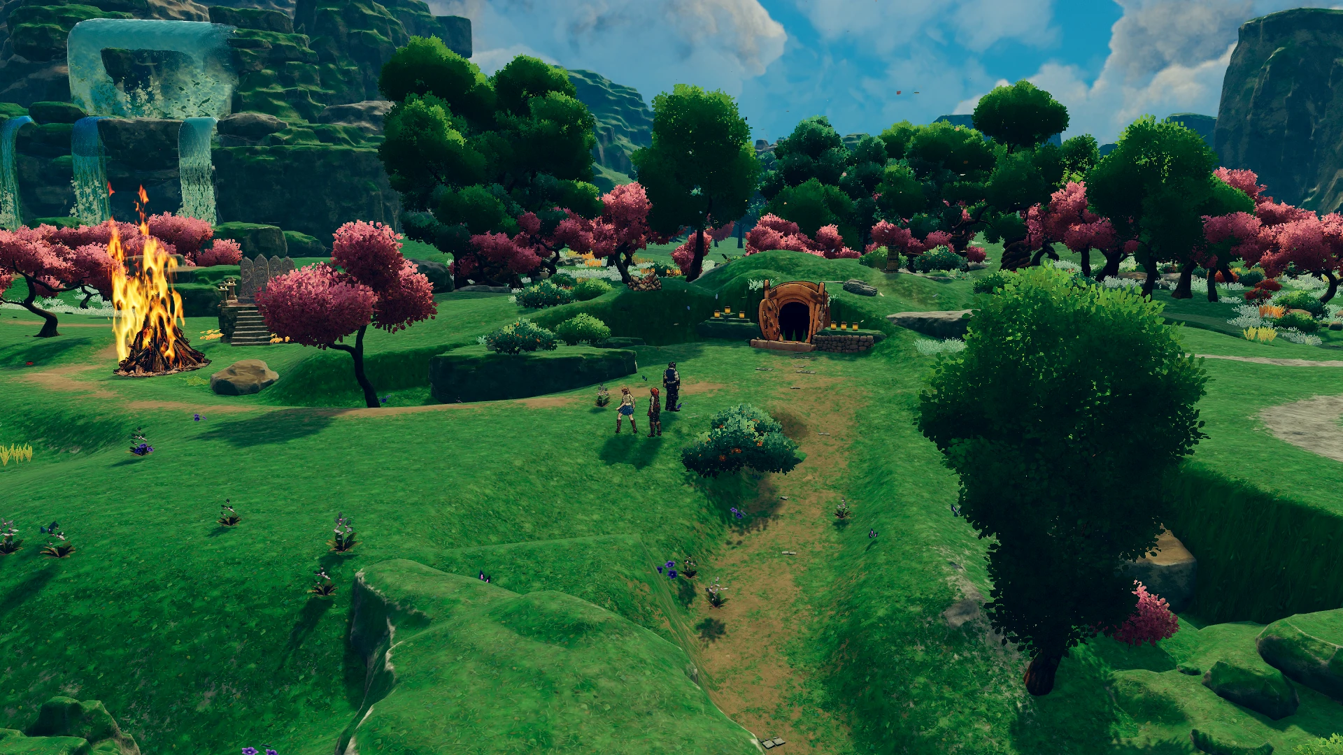 The party explores green Meadows beside a waterfall and a hillside entrance.